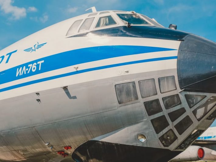 Close-up of IL-76T cargo aircraft displaying iconic Aeroflot branding at a sunny airfield.